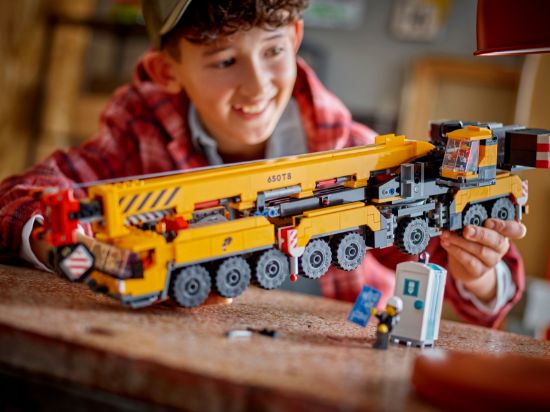 playing LEGO City 60409 Yellow Mobile Construction Crane