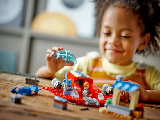 playing LEGO Star Wars 75384 The Crimson Firehawk Set
