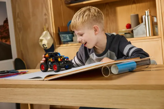 playing LEGO Technic 42219 Monster Jam™ Grave Digger™ Fire and Ice Vehicle